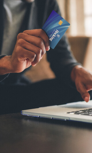 man using debit card for online shopping