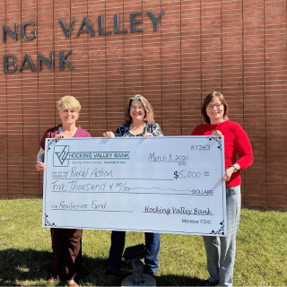 Bankers presenting a big check for $5,000 to Rural Action