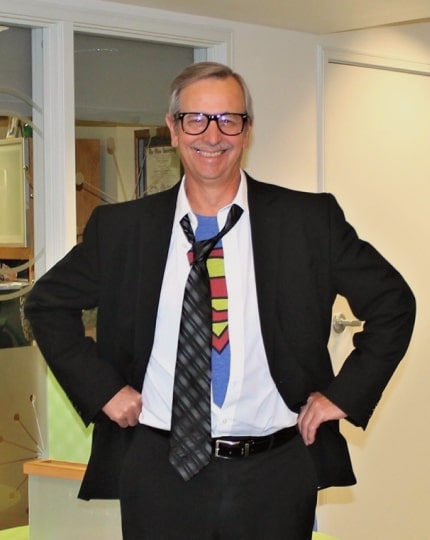Craig Sweeney dressed as Clark Kent revealing a Superman shirt