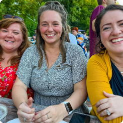 Three women smiling at a local event