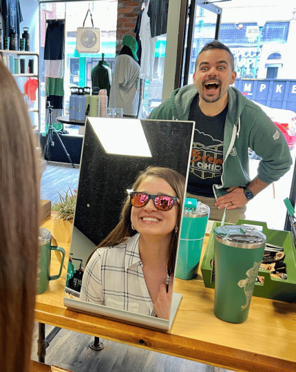 Banker trying on sunglasses at Ohio Is Home 