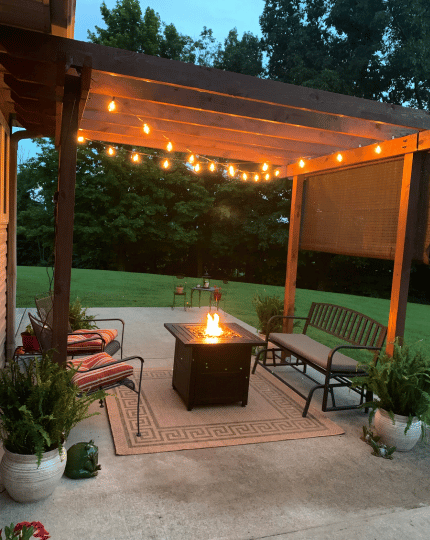 Patio with fire pit and pergola at night