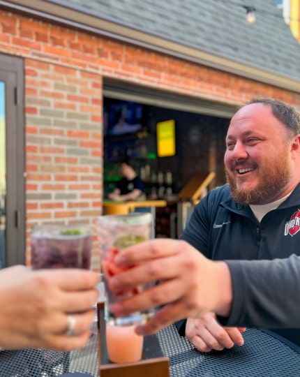 Rob Haley clinking glasses at North End