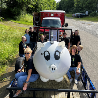 Hocking Valley Bankers and Porkchop the Pig on a parade float 